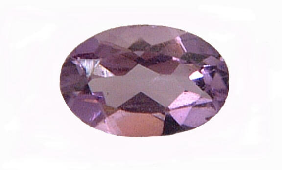 A faceted oval-cut amethyst gemstone, pale violet with its facets catching the light, photographed on a plain white background
